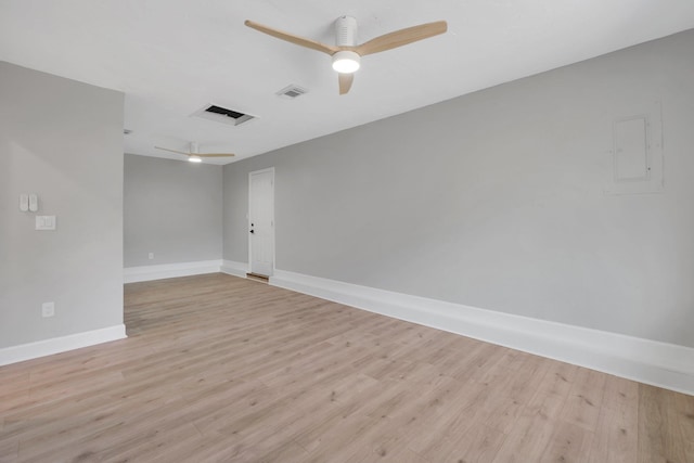 empty room with ceiling fan and light hardwood / wood-style flooring