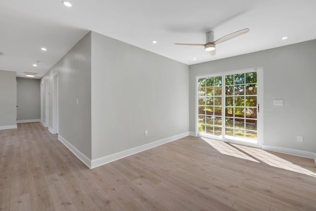 spare room featuring ceiling fan and light hardwood / wood-style flooring