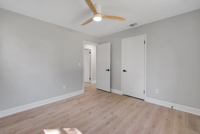 unfurnished bedroom with ceiling fan and light hardwood / wood-style flooring