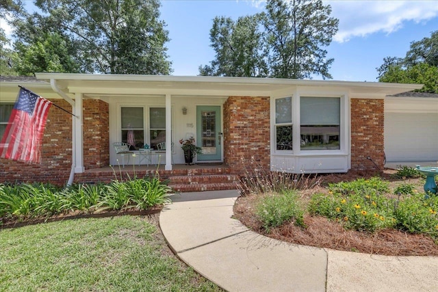 1115 Sandhurst Dr, Tallahassee, FL 32312 - ranch-style house with a porch, brick siding, and an attached garage