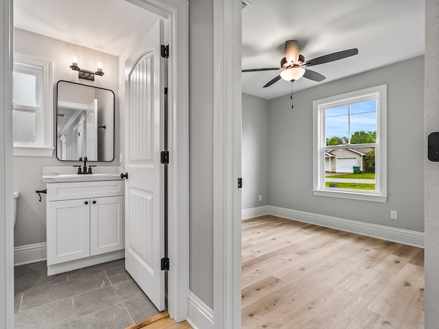 bathroom featuring hardwood / wood-style flooring, ceiling fan, and vanity