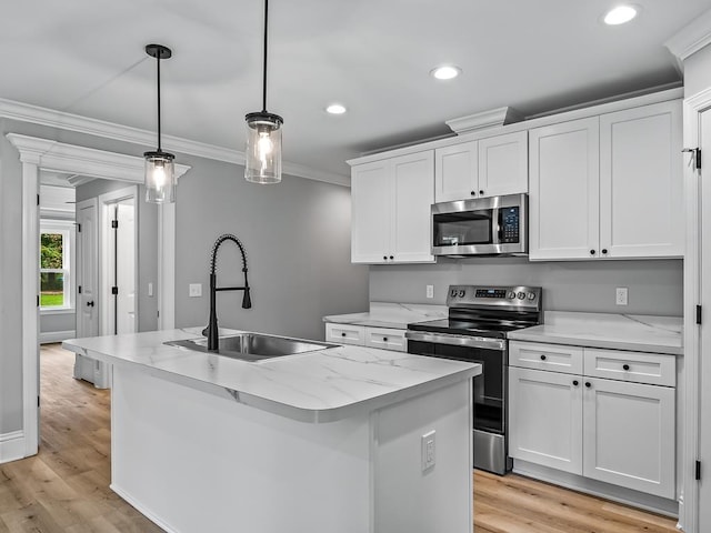 kitchen with pendant lighting, sink, a kitchen island with sink, stainless steel appliances, and white cabinets