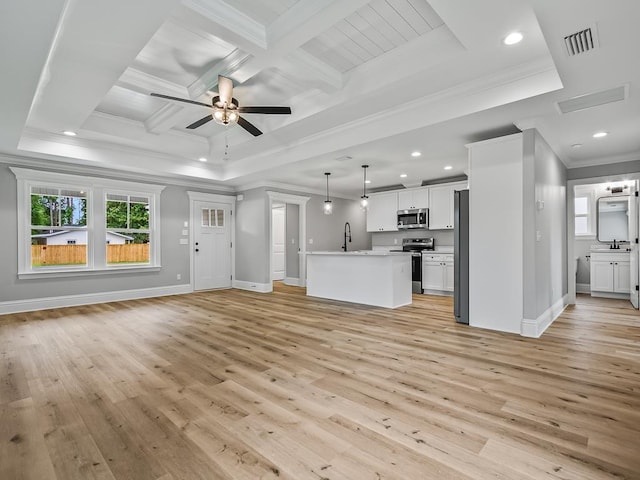 unfurnished living room with ornamental molding, sink, ceiling fan, and light wood-type flooring