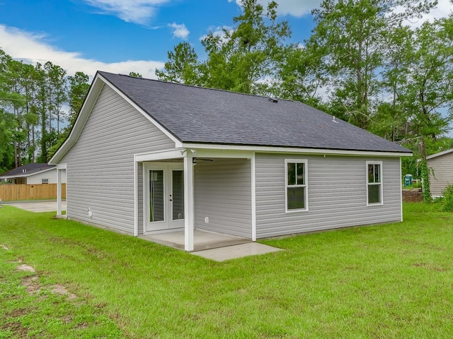 back of property with french doors, a yard, and a patio area