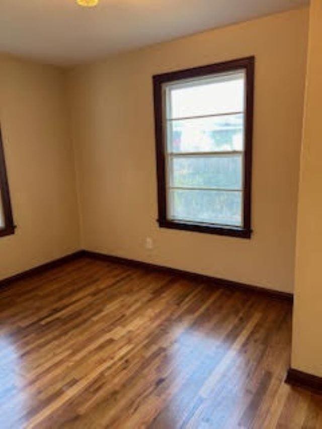 unfurnished room featuring hardwood / wood-style flooring