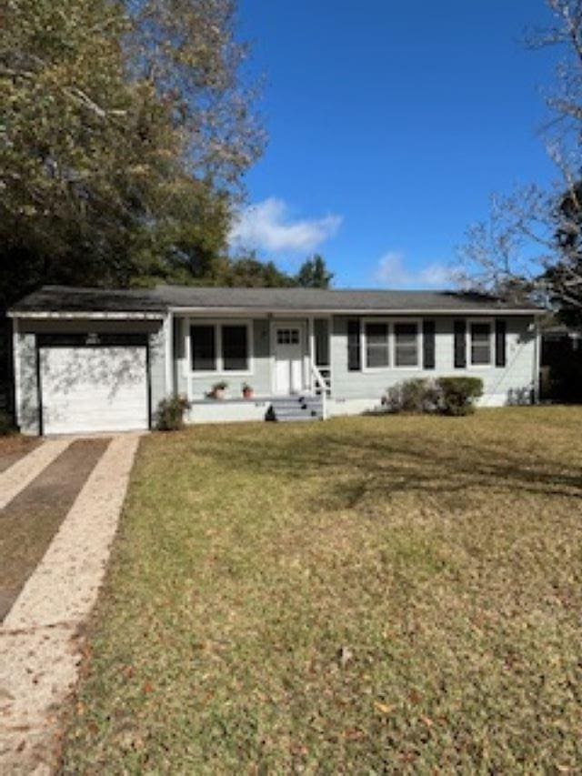 ranch-style home featuring a garage and a front lawn