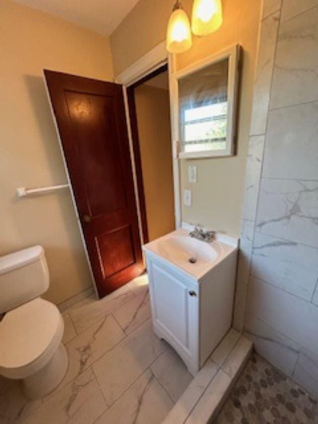 bathroom featuring vanity and toilet