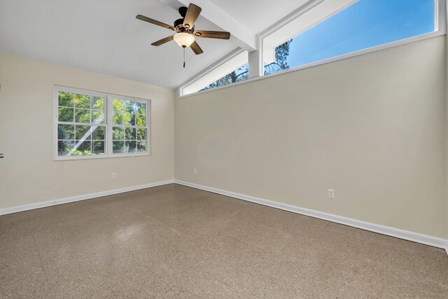 unfurnished room with lofted ceiling with beams and ceiling fan