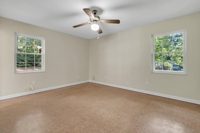 unfurnished room with a wealth of natural light and ceiling fan