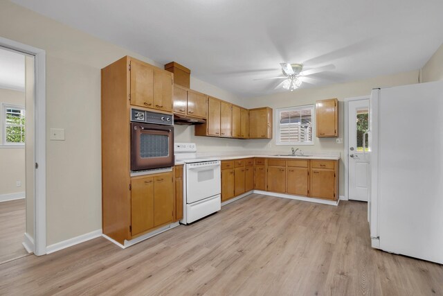 kitchen with white appliances, ceiling fan, sink, and light hardwood / wood-style floors