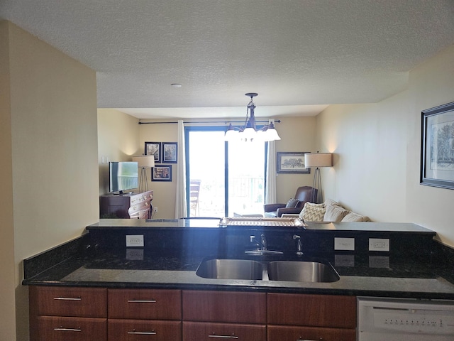 300 S Duval St Unit 1003, Tallahassee, FL 32301 - kitchen with a sink, a textured ceiling, open floor plan, white dishwasher, and a notable chandelier