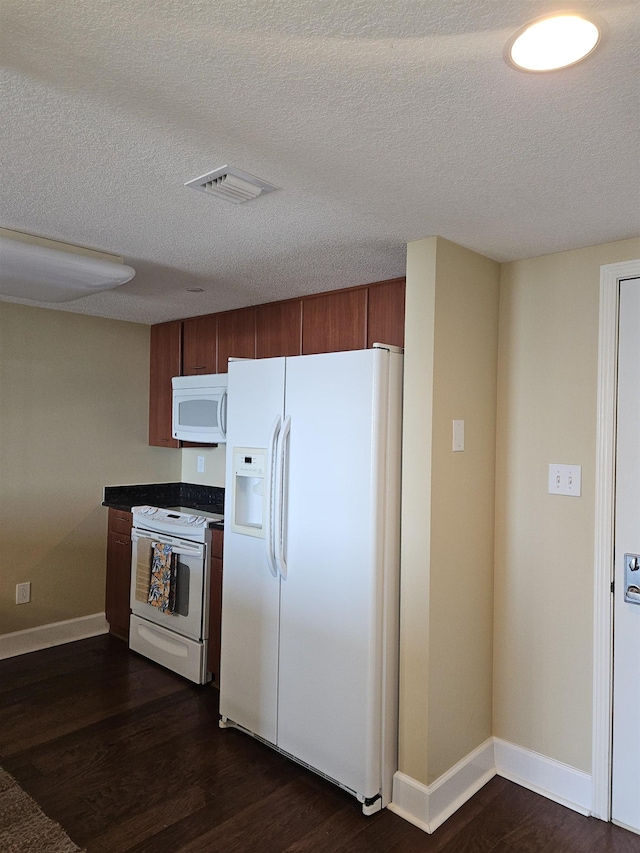 300 S Duval St Unit 1003, Tallahassee, FL 32301 - kitchen with a textured ceiling, baseboards, white appliances, visible vents, and dark wood-style floors
