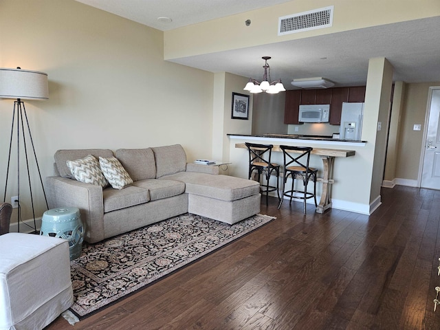 300 S Duval St Unit 1003, Tallahassee, FL 32301 - living room with baseboards, dark wood-style flooring, an inviting chandelier, and visible vents