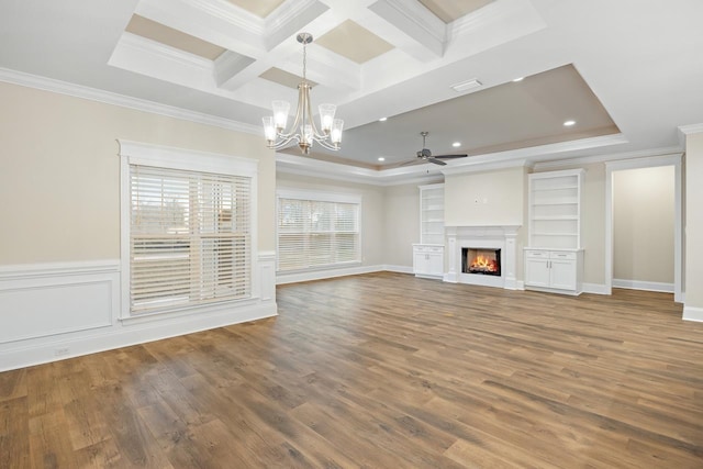 unfurnished living room featuring hardwood / wood-style floors, ornamental molding, and plenty of natural light