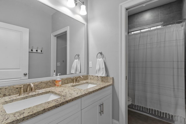 bathroom featuring a shower with curtain, vanity, and toilet