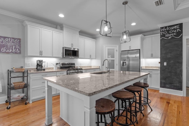 kitchen featuring stainless steel appliances and white cabinets