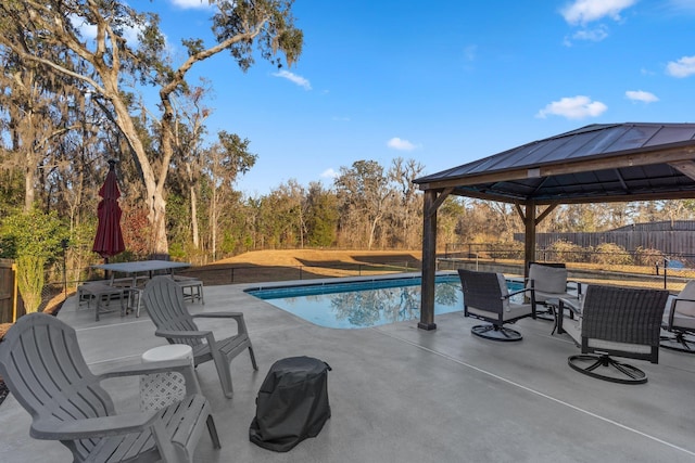 view of swimming pool with a gazebo and a patio area