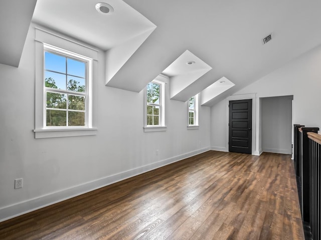 bonus room featuring visible vents, wood-type flooring, lofted ceiling, and baseboards