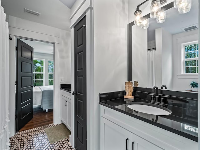 full bathroom featuring vanity, tile patterned floors, and visible vents