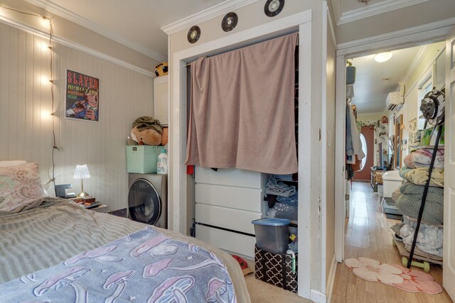 624 W 7th Ave Unit 1And 2, Tallahassee, FL 32303 - bedroom featuring ornamental molding, a wall mounted AC, washer / dryer, and wood finished floors