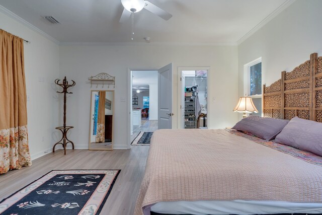 624 W 7th Ave Unit 1And 2, Tallahassee, FL 32303 - bedroom with wood finished floors, ornamental molding, a spacious closet, a closet, and a ceiling fan