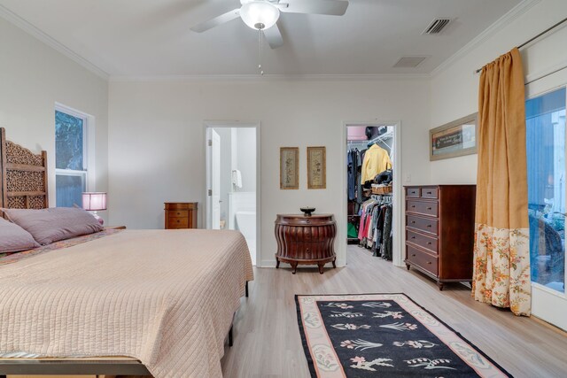 624 W 7th Ave Unit 1And 2, Tallahassee, FL 32303 - bedroom featuring ornamental molding, a walk in closet, light wood-type flooring, a closet, and ensuite bathroom