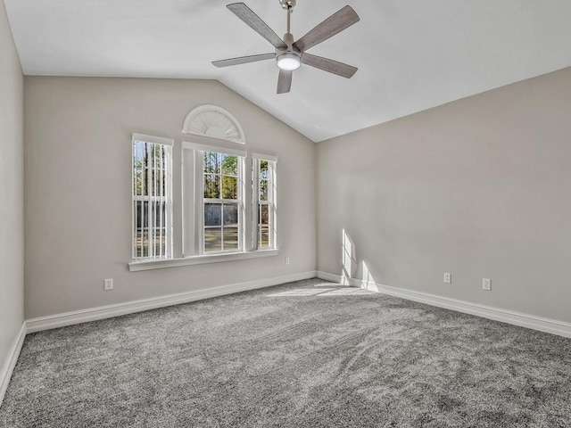 carpeted empty room with lofted ceiling, ceiling fan, and baseboards