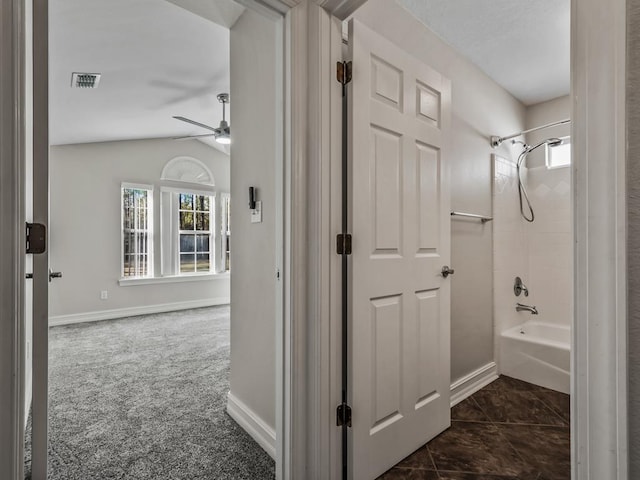 full bath featuring shower / bathtub combination, lofted ceiling, visible vents, a ceiling fan, and baseboards