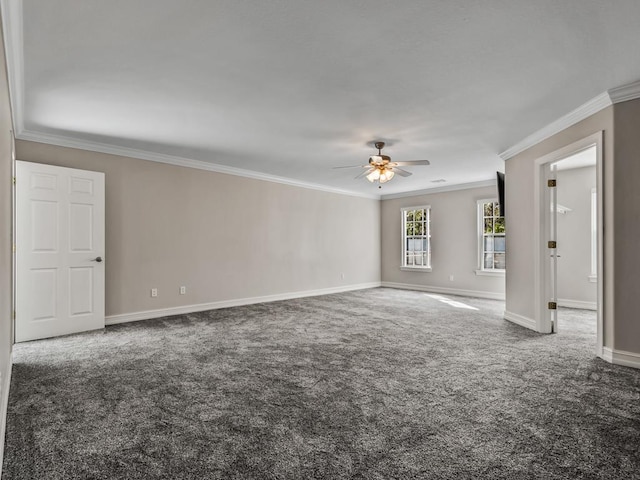 empty room with a ceiling fan, baseboards, dark carpet, and crown molding