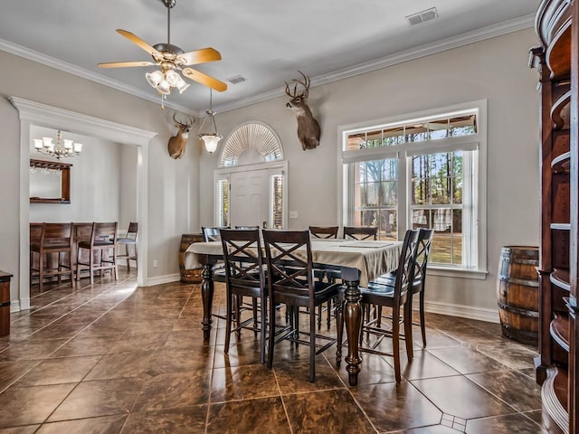 dining space with ornamental molding, visible vents, and baseboards