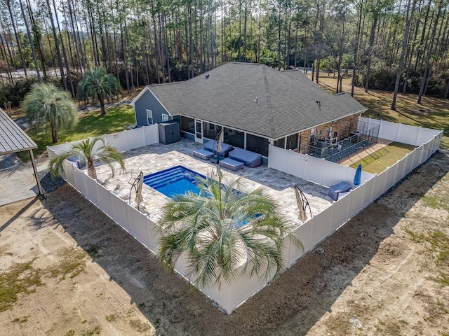 view of swimming pool with a patio area, a fenced backyard, an outdoor living space, and a fenced in pool