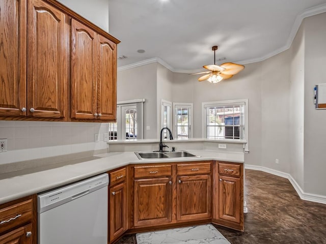 kitchen with light countertops, brown cabinetry, white dishwasher, and a sink