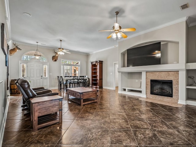 living room featuring ornamental molding, visible vents, and baseboards