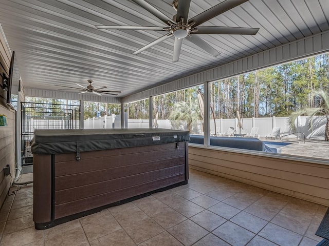 sunroom / solarium with plenty of natural light and ceiling fan