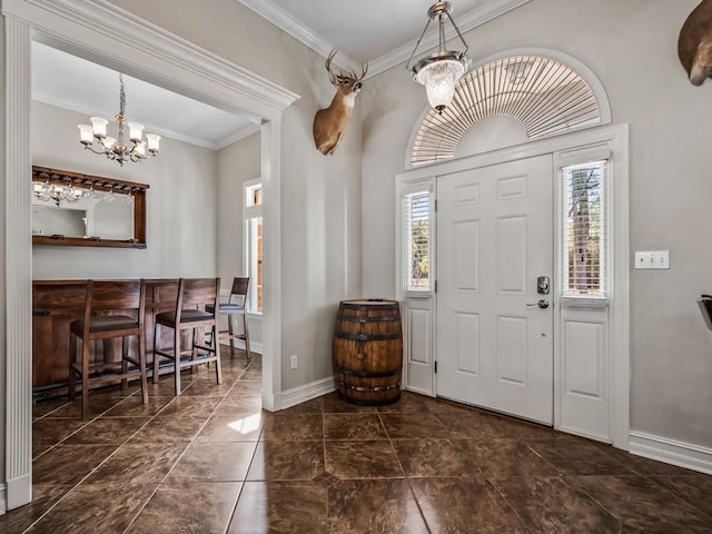 entryway with an inviting chandelier, baseboards, and ornamental molding