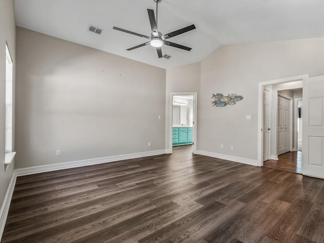 unfurnished bedroom featuring baseboards, visible vents, lofted ceiling, dark wood-style floors, and ensuite bath