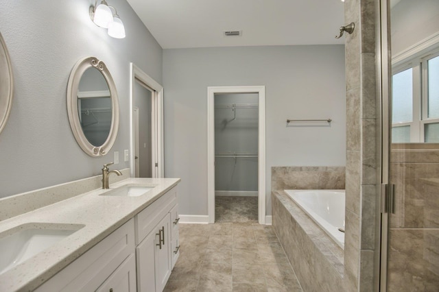 bathroom with separate shower and tub, tile patterned floors, and vanity