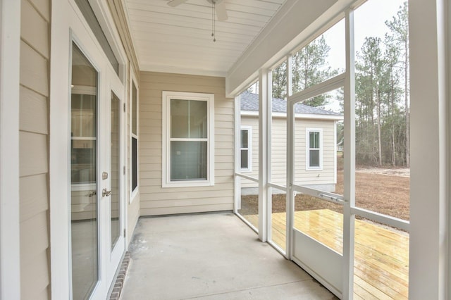 unfurnished sunroom with ceiling fan and a healthy amount of sunlight