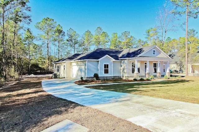 view of front facade with covered porch, a garage, a front lawn, and central air condition unit