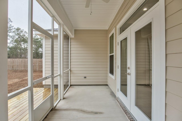 unfurnished sunroom with ceiling fan