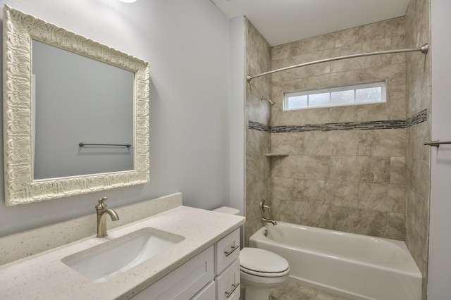 full bathroom featuring tiled shower / bath combo, toilet, and vanity