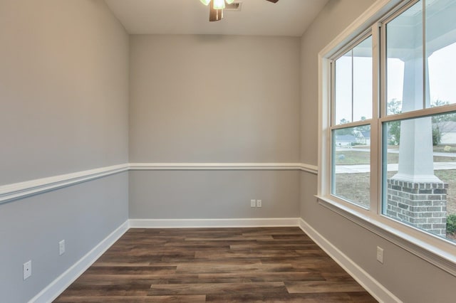 empty room with ceiling fan and dark wood-type flooring