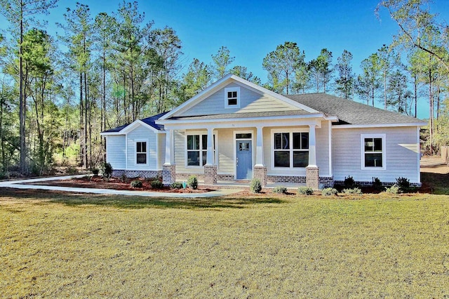 view of front of house with covered porch and a front yard