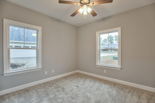 empty room with ceiling fan and light carpet