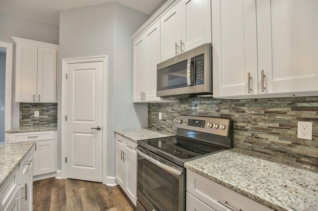 kitchen with white cabinetry, dark wood-type flooring, and appliances with stainless steel finishes