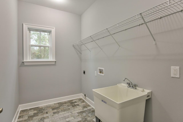 laundry area with hookup for an electric dryer, sink, and hookup for a washing machine