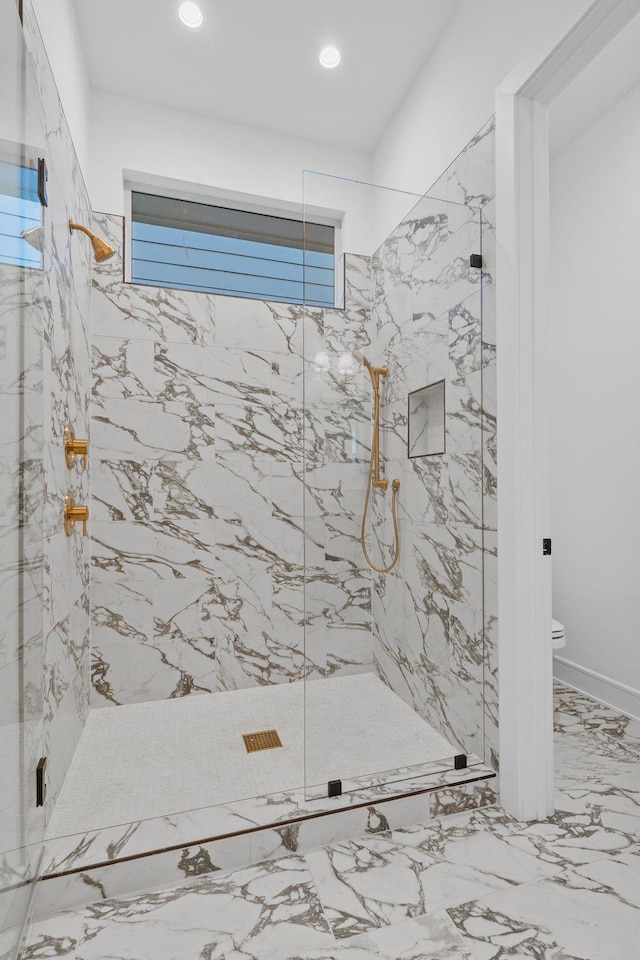 bathroom with tiled shower and toilet