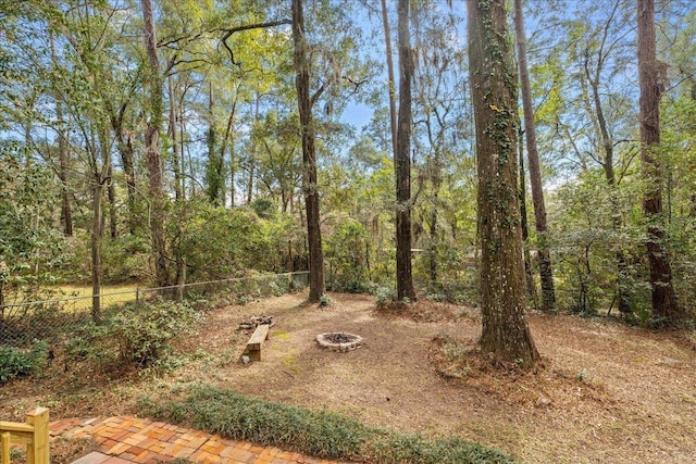 view of yard with fence and a fire pit