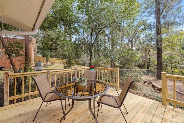 wooden terrace featuring outdoor dining area and fence