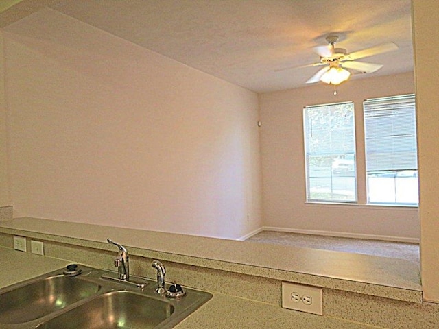 kitchen featuring sink and ceiling fan